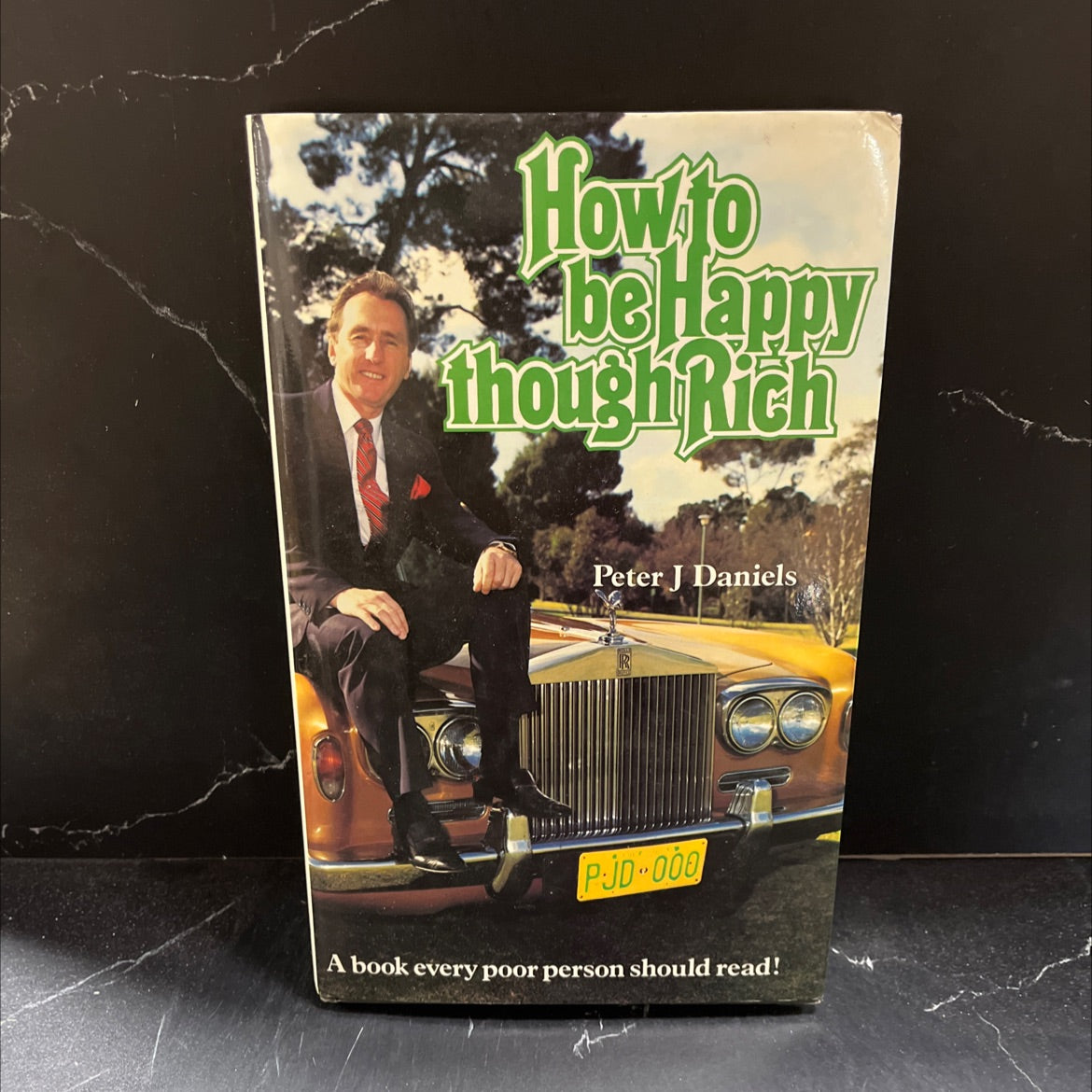 how to be happy though rich book, by Peter J. Daniels, 1984 Hardcover image 1